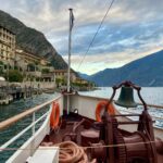 Beautiful view from a ship in Limone Sul Garda, Italy showing waterfront and mountain landscapes.